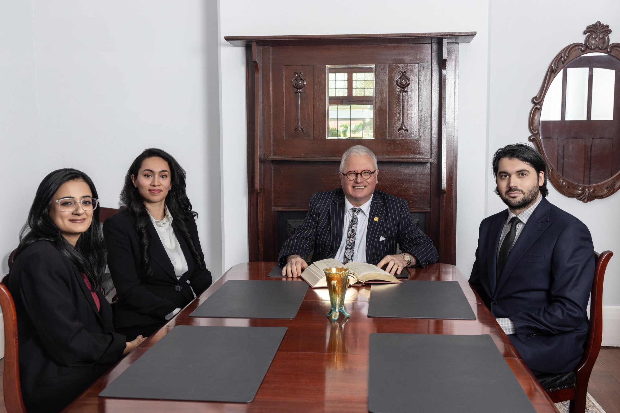 The Steven M Clark Lawyers team at the boardroom table